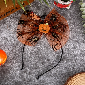 Halloween headband with orange mesh bow and sparkling pumpkin on a grey festive background