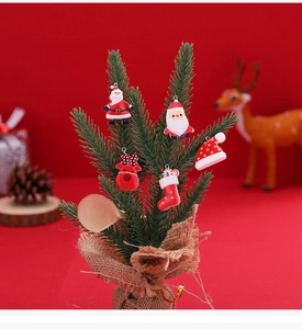 Detail of colorful resin Christmas ornaments including Santa and reindeer on a tree