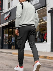 Street-style shot of men's dark grey multi-pocket cargo joggers in a casual walking pose