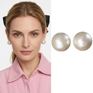 Elegant round champagne pearl stud earrings for women with minimalist golden metallic finish