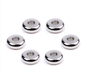Detailed macro view of silver stainless steel spacer beads for DIY jewelry making projects