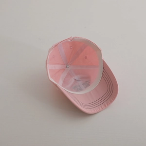Detailed interior view of pink cotton baseball cap with sweatband and reinforced stitching