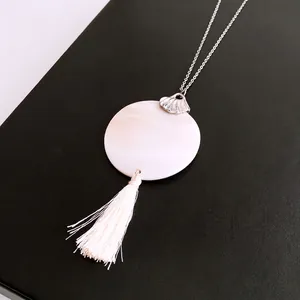 Elegant silver chain necklace featuring white shell pendant and fringe tassel on black leather