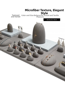 Detail of luxury microfiber jewelry display stands with gray terrazzo base for necklaces