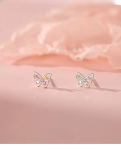 Macro detail of S925 silver butterfly stud earrings with colorful zircon crystals
