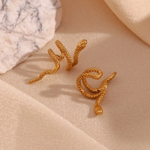 Detailed macro view of 18K gold plated stainless steel snake earrings with textured scales