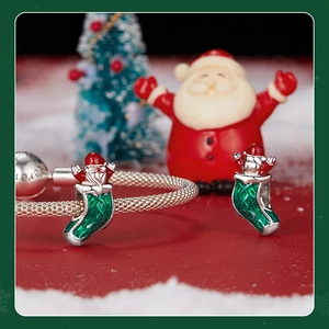 Macro view of sterling silver Santa in Christmas stocking charm with enamel details