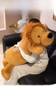 Cuddly large plush lion pillow with fluffy mane held by person for size reference