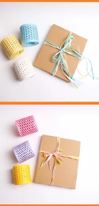 Close-up of multicolored raffia paper ropes used for eco-friendly gift box packaging