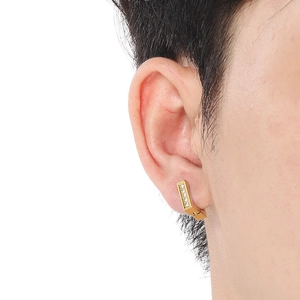 Macro side view of a gold square hoop earring with five inset crystals on a model