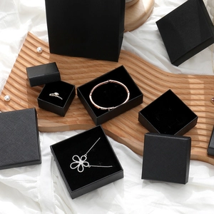 Detail of premium black textured jewelry boxes including ring, necklace boxes and gift bag