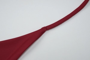 Close-up of wine red knit strap with reinforced stitching and textured fabric detail