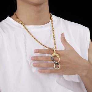 Close-up of a dual-color dragon infinity symbol pendant on a male model's neck