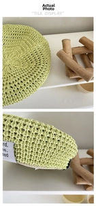 Detail of light green hollow-out knit beret showing breathable mesh texture and lining
