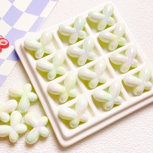 Macro detail of pearlescent white butterfly beads for DIY jewelry and phone chains