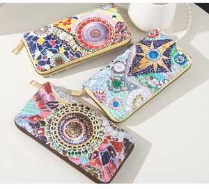 Detail view of multi-color mosaic pattern leather wallets with metal zipper closure