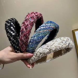 Detail of four colorful tweed headbands with sequins and woven texture