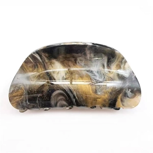 Elegant marble pattern hair claw clip with golden glitter finish on white background