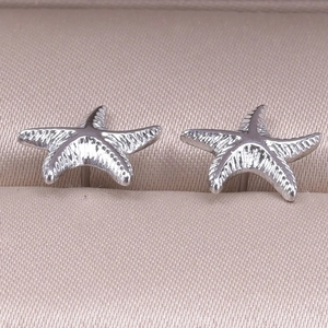 Macro shot of 304 stainless steel starfish earrings with realistic textured metal finish