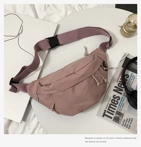 Detail view of pink crossbody bag with adjustable strap and smooth nylon texture