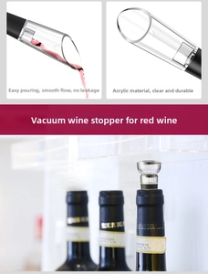 Macro detail of acrylic wine pourer and vacuum stopper with black silicone base