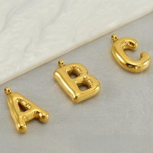 Detailed view of three 3D golden balloon letter pendants A, B, and C with shiny finish