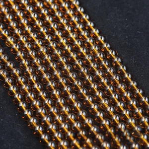 Macro shot of transparent amber glass beads for DIY jewelry with smooth polished finish