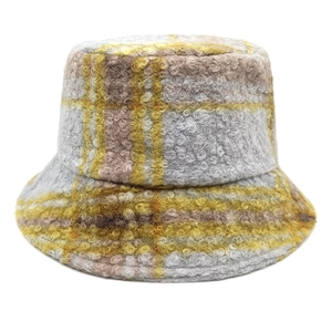 Winter teddy fleece bucket hat featuring classic yellow and grey plaid pattern on white background