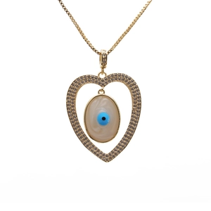 Golden geometric heart pendant necklace with diamond-set evil eye on white background