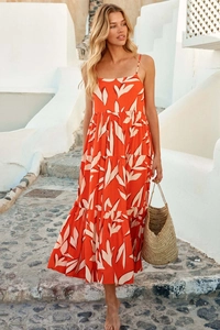 Detail of bohemian orange floral maxi dress with spaghetti straps and tiered skirt