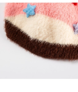 Close-up of soft striped plush pet sweater with colorful fuzzy star patches