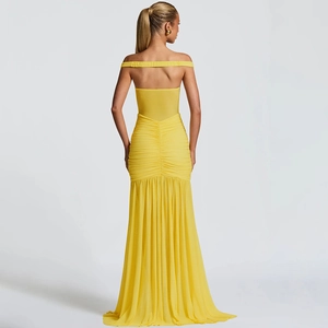 Detail showing high-waisted ruched bodice and pleated mesh skirt of yellow tube dress