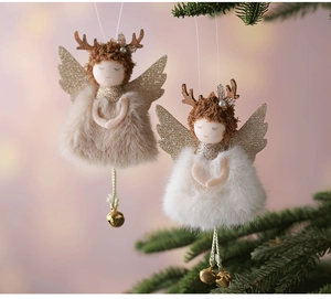 Close-up of plush Christmas angel reindeer ornaments with bells hanging on a tree