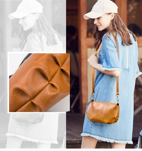 Detail of textured brown leather crossbody bag with outdoor model lifestyle view