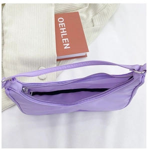 Top view of purple nylon crossbody bag showing the zipper opening and black inner lining