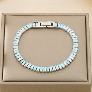 Detailed shot of silver bracelet with iridescent crystals on a premium jewelry box