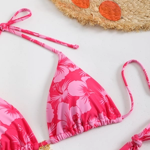 Close-up of pink hibiscus print bikini top with triangle cups and gold metal rings
