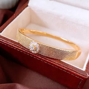 18K gold plated mesh bangle with a sparkling crystal flower motif in a gift box
