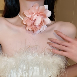 Close-up of a large pink fabric floral choker necklace on a model for a sweet style look