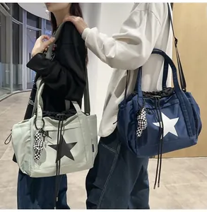 Detail of waterproof nylon drawstring bags with star pattern and cute checkered doll charm