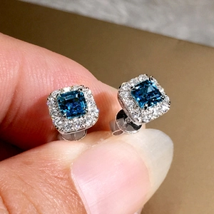 Sparkling square cut emerald green zircon stud earrings with silver pavé halo detail
