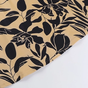 Close-up of ginger floral dress fabric with fine printing and double-stitch seam detail