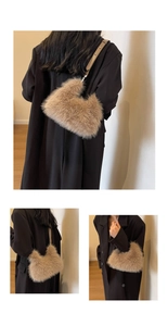 Close-up of fluffy brown faux fur texture and leather strap on a winter shoulder bag