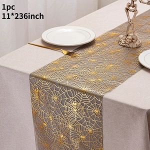 Detail of 11x236 inch gold spider web table runner on a gray background for Halloween