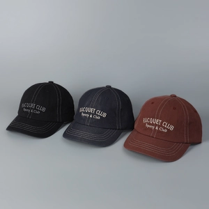 Detailed view of three vintage-style short-brim baseball caps with custom embroidery