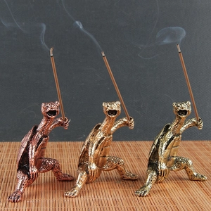 Detailed view of three vintage turtle incense holders in bronze, gold and copper finishes
