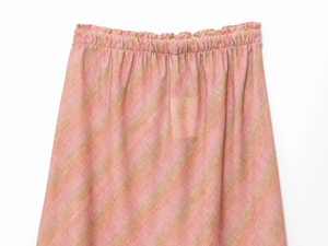 Detail of elastic waistband on pink and green diagonal striped linen midi skirt