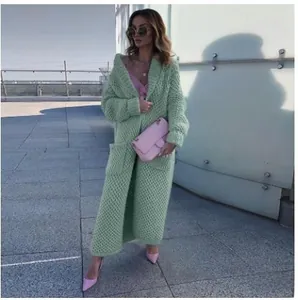 Detail of green long chunky knit cardigan with honeycomb texture and lapel collar