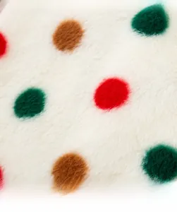 Detail of warm flannel fabric with red, green, and brown polka dots for large dog fleece