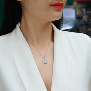 Elegant S925 silver halo necklace with round moissanite pendant worn by a model